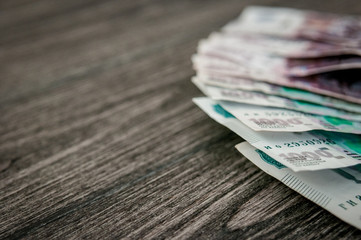 Russian ruble banknotes, money on dark wood background