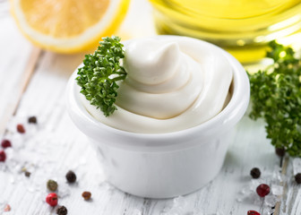 Mayonnaise sauce and ingredients on white