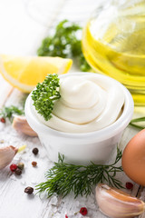 Mayonnaise sauce and ingredients on white
