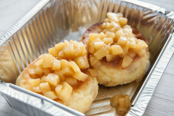 Healthy food in foil box, diet concept. Apple dessert