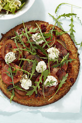 Healthy quinoa pizza with tomatoes and sun dried tomatoes and goats cheese