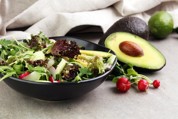 avocado, radish, sesame and arugula salad. Healthy vegan food. allergy-friendly, clean eating and raw diet.