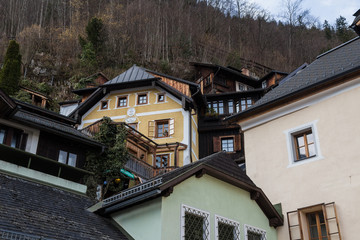 Stacked wooden houses with a waterfall in Hallstat, Austria