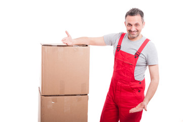 Mover man smiling and showing cardboard boxes
