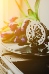 Vintage gramophone with a vinyl and flowers