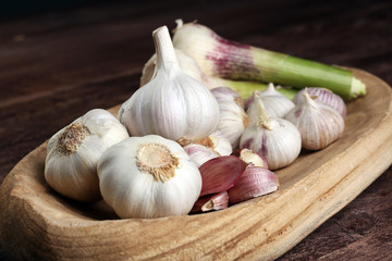 Garlic. Garlic Cloves and Garlic Bulb in vintage wooden bowl.