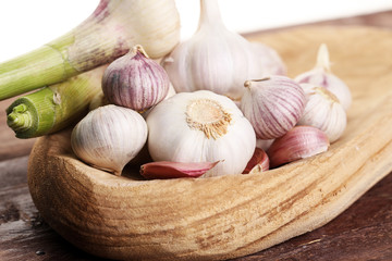Garlic. Garlic Cloves and Garlic Bulb in vintage wooden bowl.