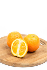 Sliced oranges on the wooden board isolated over white with copy space