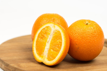 Sliced oranges on the wooden board isolated over white with copy space