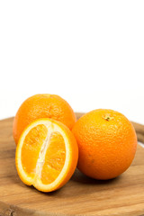 Sliced oranges on the wooden board isolated over white with copy space