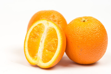 Three sliced oranges isolated over white background