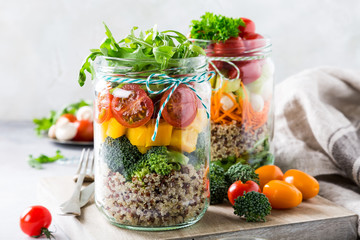 Glass jar with quinoa and vegetables salad. Healthy food, diet, detox, clean eating and vegetarian concept.