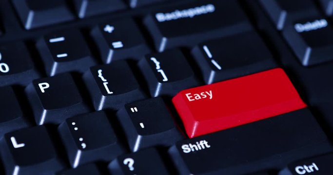 Video footage of human finger presses a red Easy button on the computer keyboard