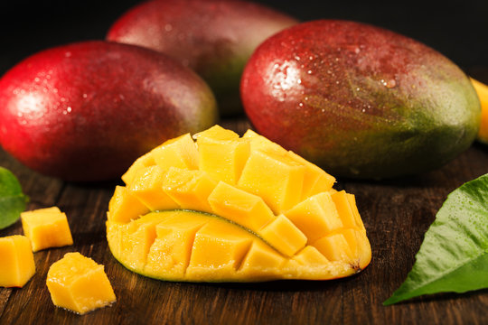 Some mango on wooded board.