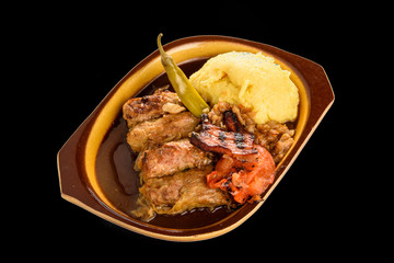 meat rolls sarmale in clay bowl isolated