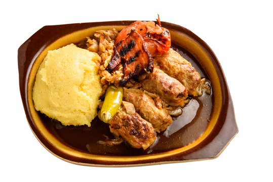 meat rolls sarmale in clay bowl isolated