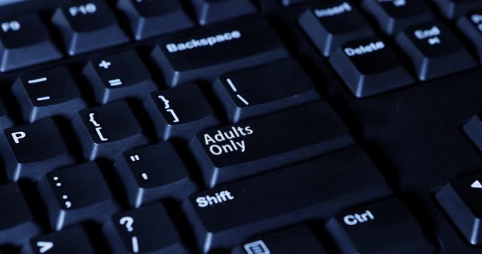 Male finger pressing an Adult Only button on the computer keyboard