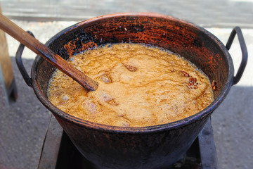 Pot of caramel, making sugared almonds, Sineu market, Spain