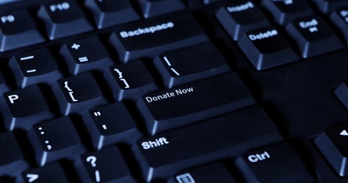 Video footage of a male finger pressing a Donate Now button