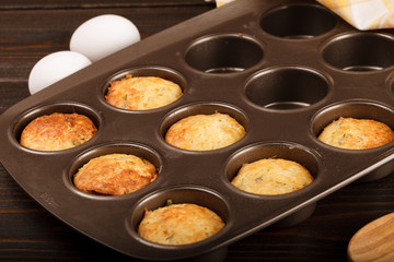 Muffins with cheese on dark wood backgroud