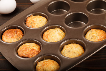 Muffins with cheese on dark wood backgroud