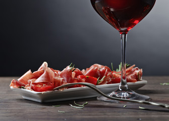  Prosciutto with  rosemary and glass of red wine