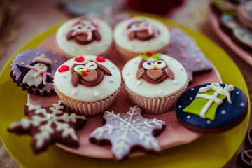 Christmas cupcakes with funny sheeps on pink plate