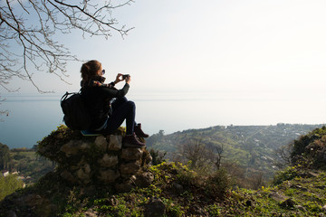 woman take a picture in mountain by phone