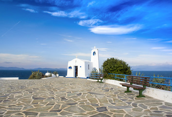 Typical greek place with a white small orthodox chapel dedicated to St. Nikolaos.Rafina,Greece