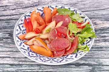 Spicy sour mixed vegetable salad with sausage and Chinese sausage.