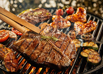 healthy lean t-bone steak grilling on a BBQ