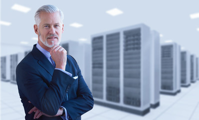 Senior businessman in server room