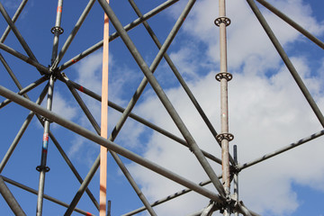 Metal structures that are installed to create a scene outdoors against the sky.