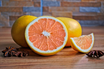 Closeup of grapefruits and star anise on a wooden table