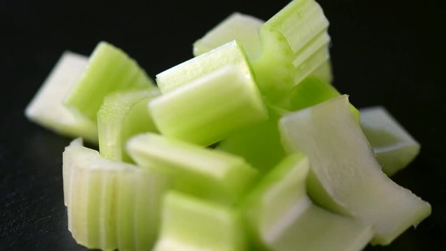 Celery closeup rotation over black background. 4K UHD video footage. Ultra high definition 3840X2160