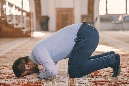 Muslim prostrating on the carpet floor