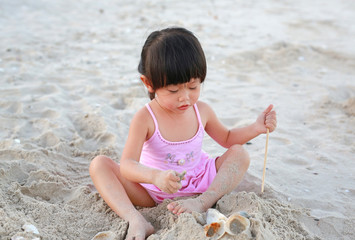 Portrait Kid girl playing sand at the beach