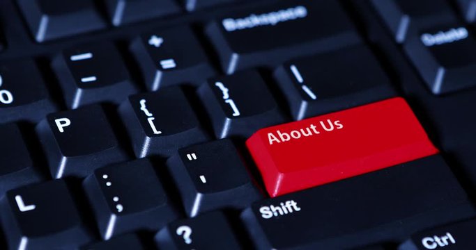 Close up of male hand pressing a red button with text of About Us on the computer keyboard
