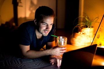 Side view of nice guy watching funny videos on internet.