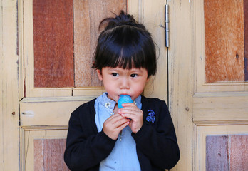 Cute little girl sucking lollipop. Tiny kid enjoying her sweet yummy popsicle.