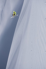 Flying skier on mountains. Extreme winter sport.