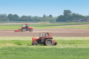 Fototapeta premium Tractors cutting lucerne