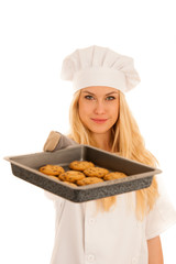 beautiful blond woman in chef dress bakes cookies isolated over white background