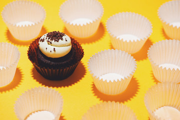 Birthday cupcake against a yellow background