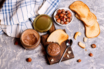 Chocolate paste spread with hazelnuts and bread for breakfast