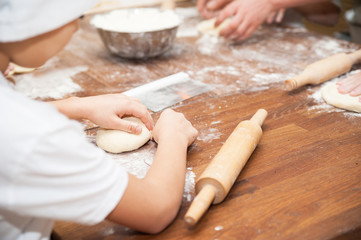 Young children make dough. Hands close up