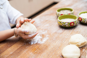 Young children make dough. Hands close up