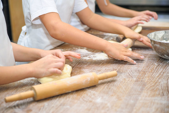 Young children make dough. Hands close up