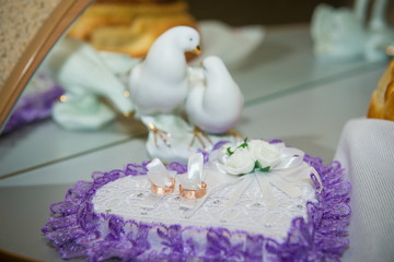 Two rings on  pillow in the shape of heart. Wedding Rings, Symbol of Love and Fidelity.
