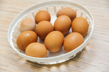 many brown eggs in a plate